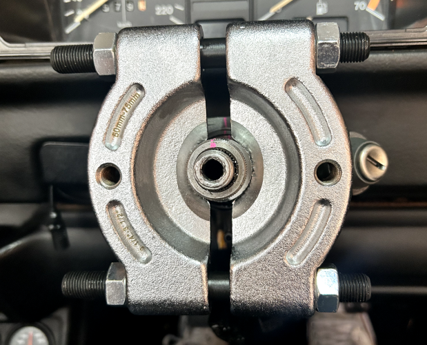 Using a bearing separator to remove the steering column adaptor sleeve